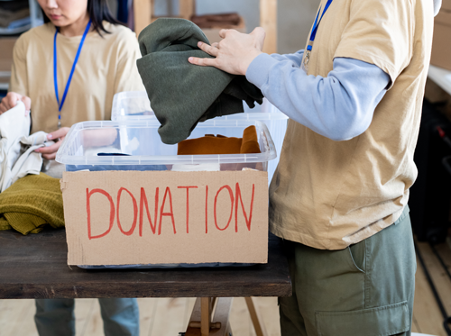 a-man-and-a-woman-choosing-donation-clothes